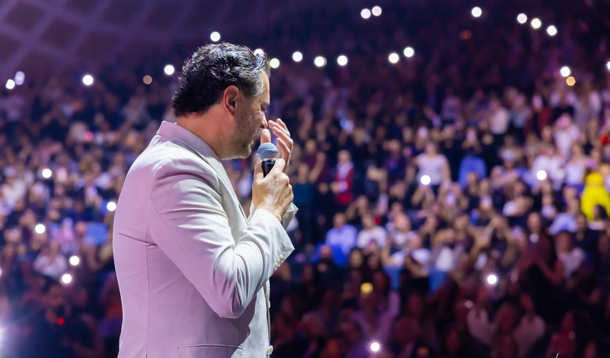 Ragheb Alama singing to a sold-out ICC Sydney with phone lights raised